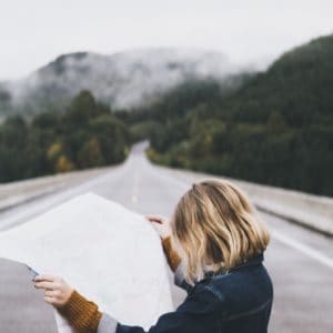 Short hair blonde woman reading map of non-diet goals