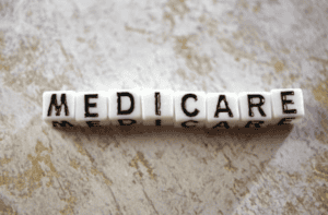 The words 'medicare' written out using a scramble block letters